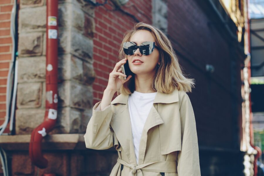Woman walking city street trench coat spring