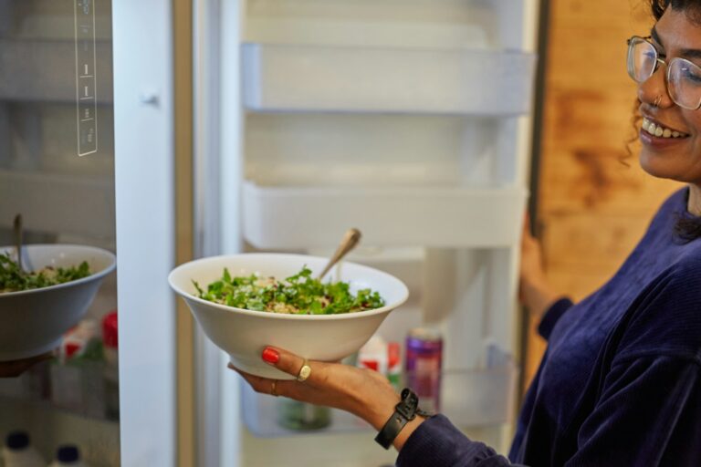 Woman choosing snack fridge