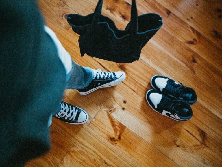 Two pairs travel shoes wooden floor