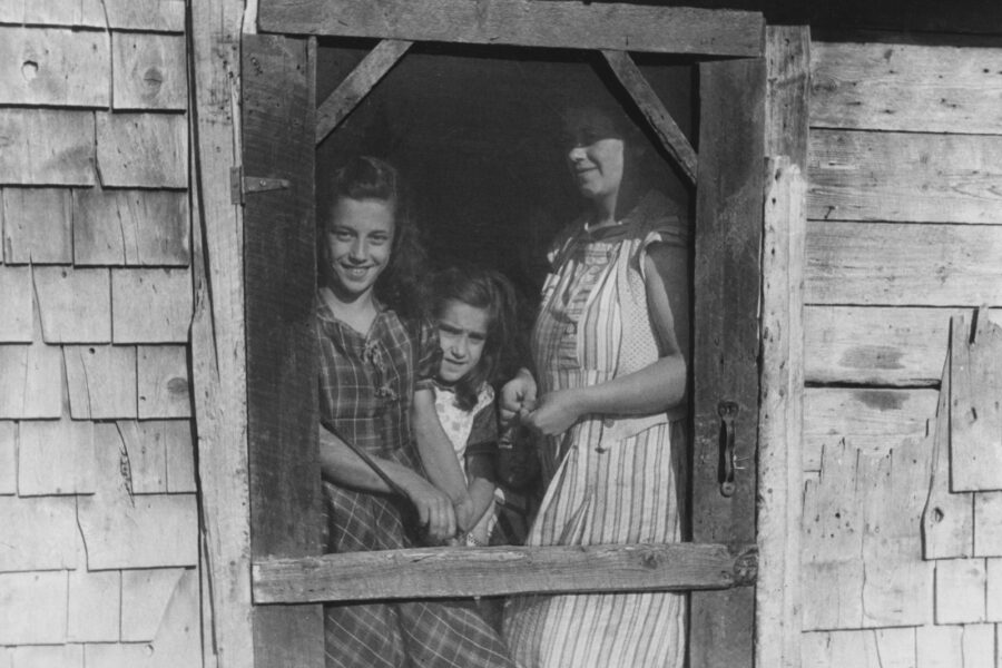 Working parent arriving home doorway hug