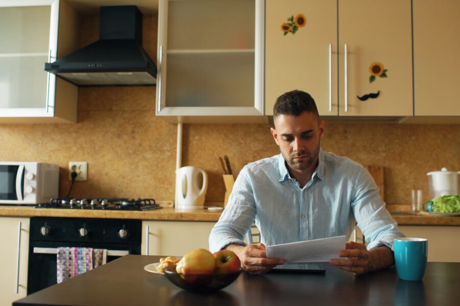 Person reading newspaper coffee kitchen table