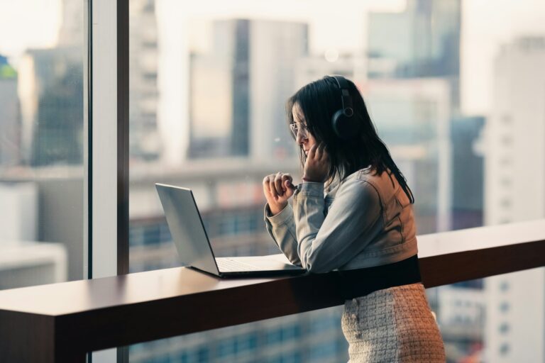 Woman stretching near laptop window