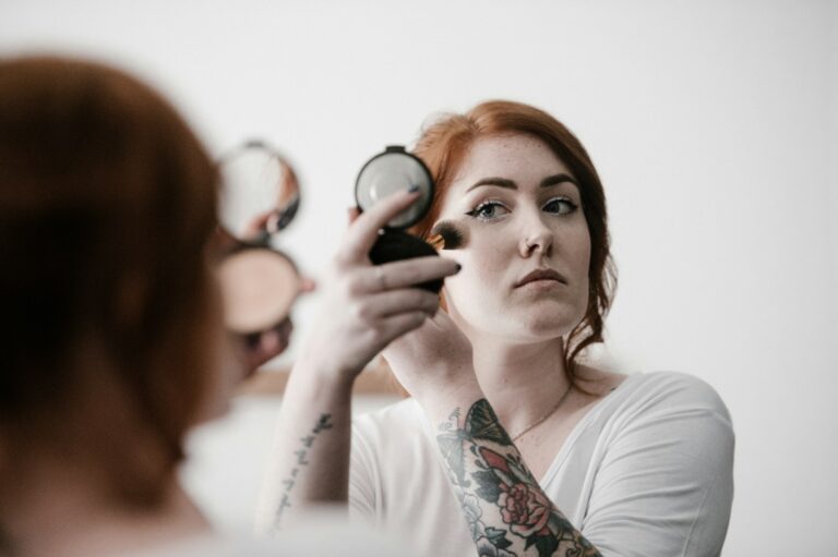 Woman applying cream blush natural light