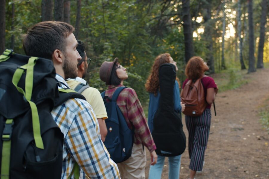 Family hiking forest trail backpacks