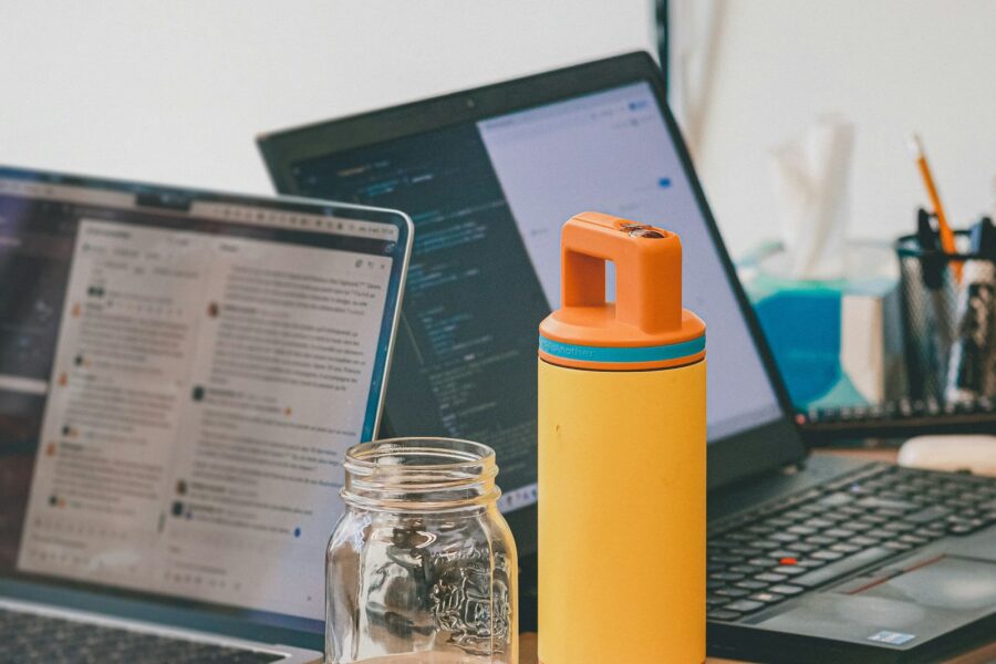 Reusable water bottle desk notebook laptop