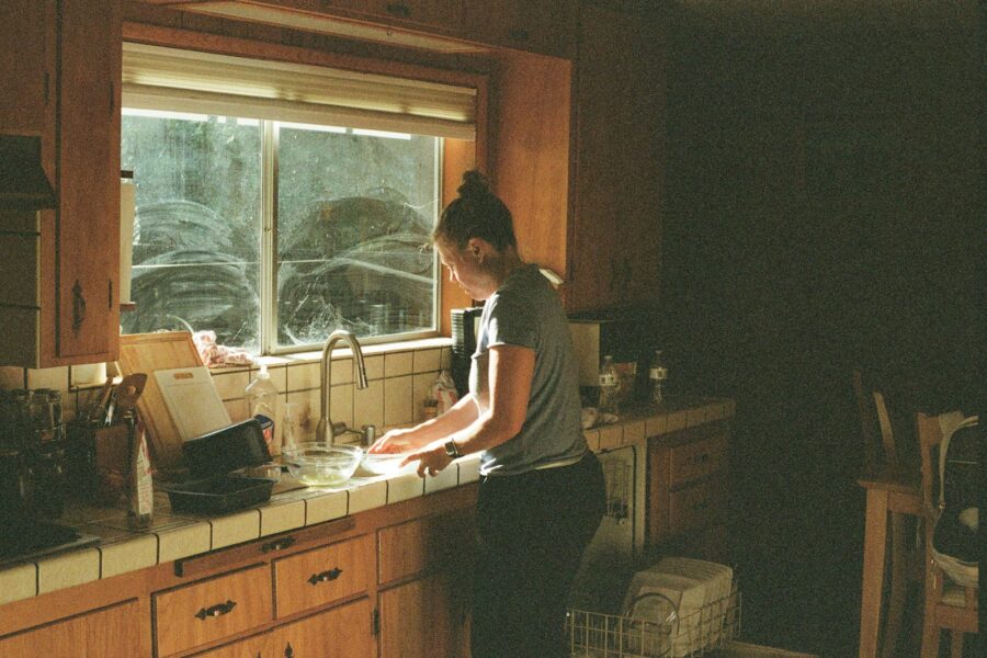Couple washing dishes together kitchen