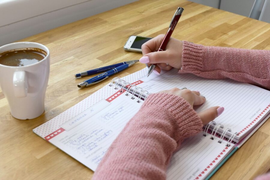Person desk planner notebook coffee