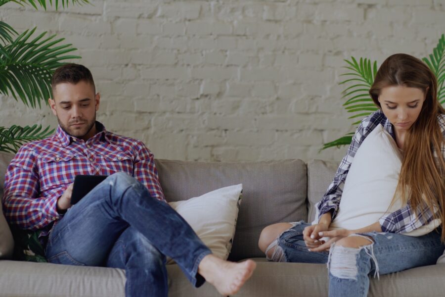 Couple sitting sofa drinking coffee