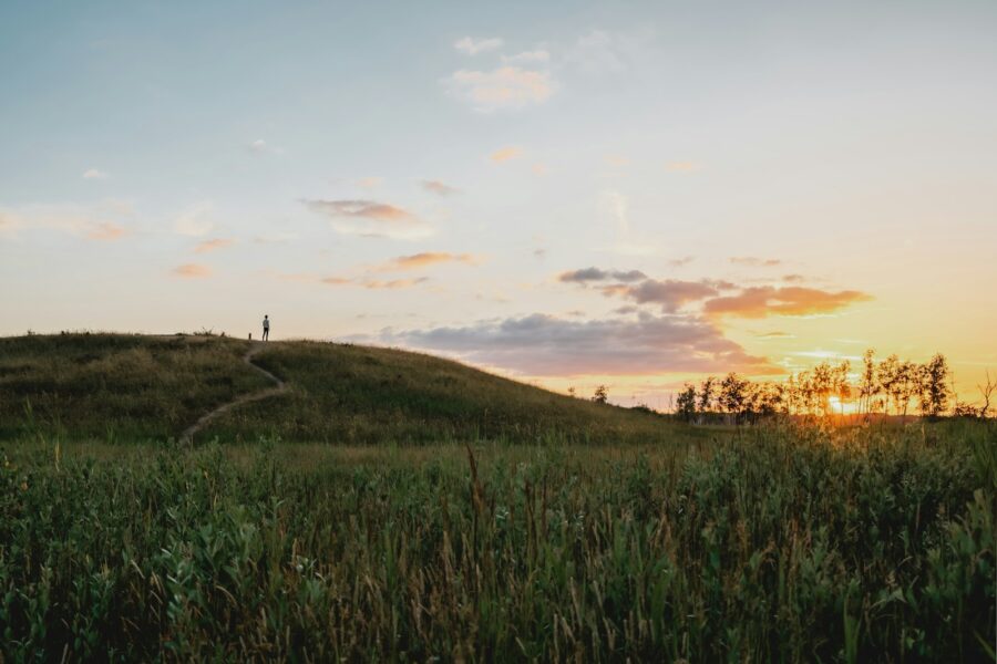 Person walking small hill sunrise