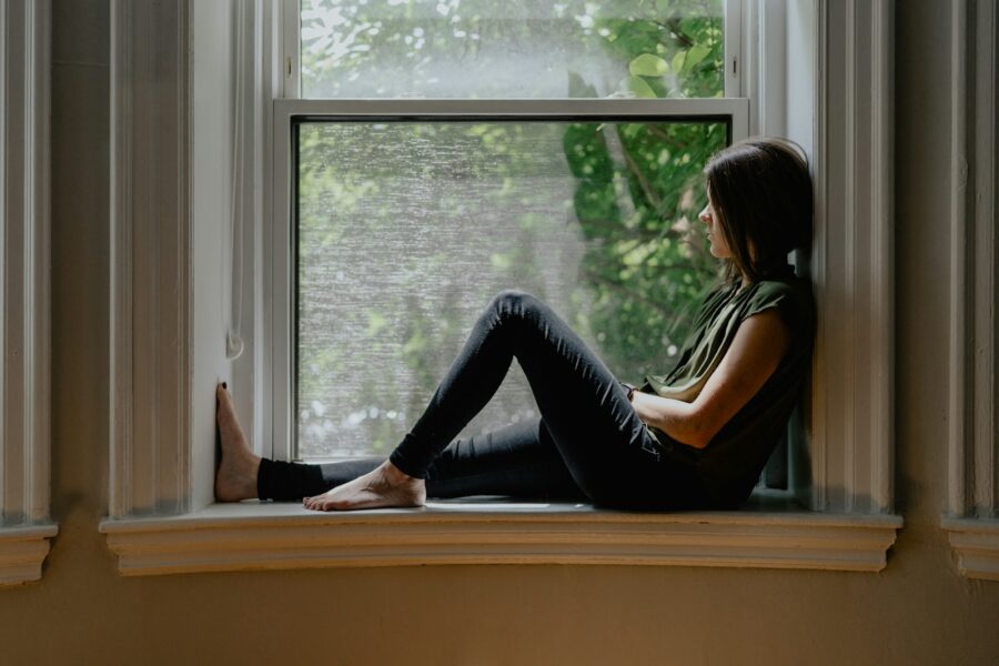 Woman sitting window morning sunlight