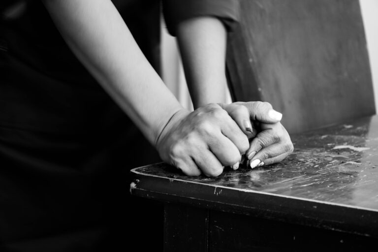 Close hands stretching desk