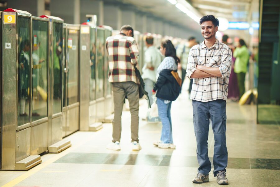 Person using phone metro station platform