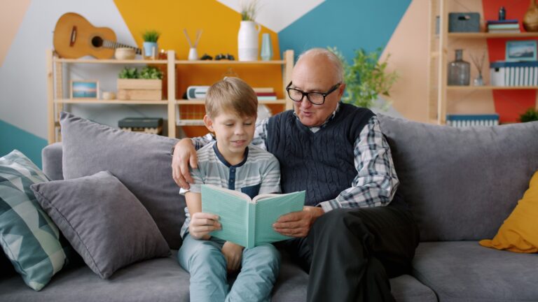Grandmother grandchild reading book couch
