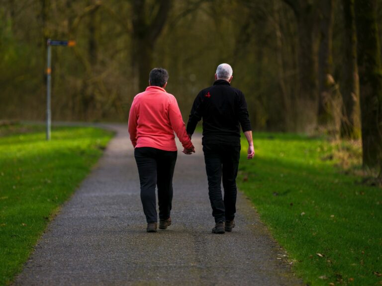 Couple walking park holding hands