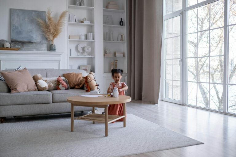 Child cleaning toys living room floor