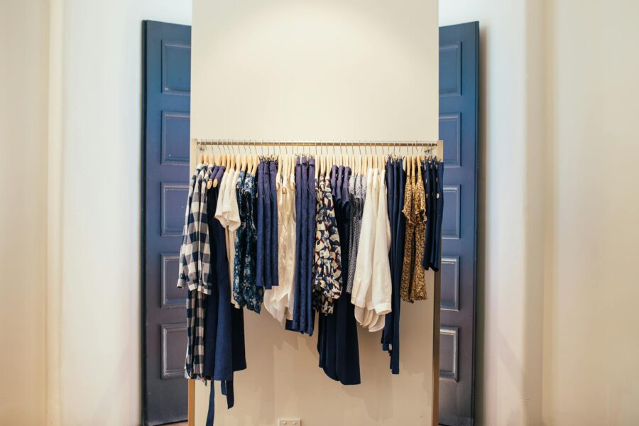 Neatly organized neutral capsule wardrobe rail
