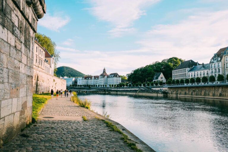 Riverside path small town people walking summer greenery