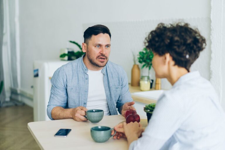 Couple kitchen having conversation parent teenager talking table