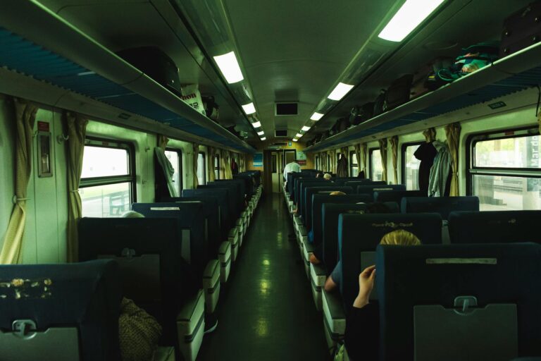 Train interior aisle passengers luggage