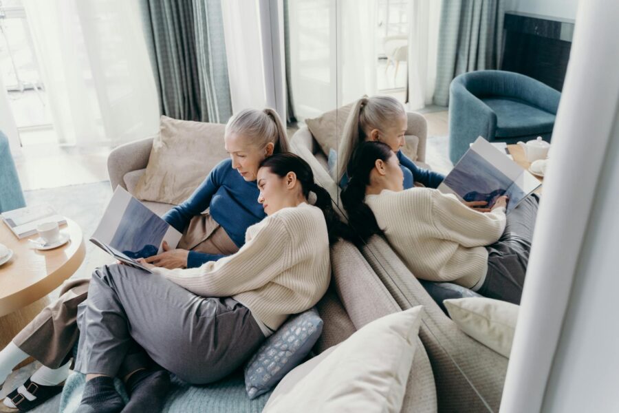 Adult daughter talking older mother sofa