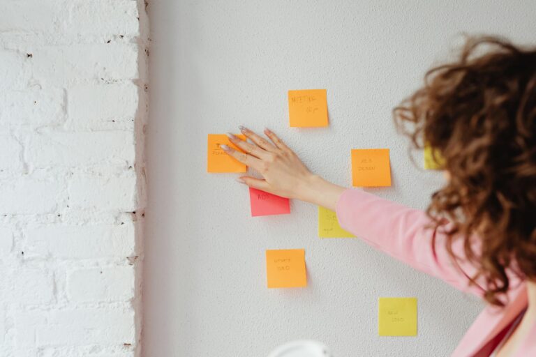Colorful weekly wall calendar sticky notes woman writing
