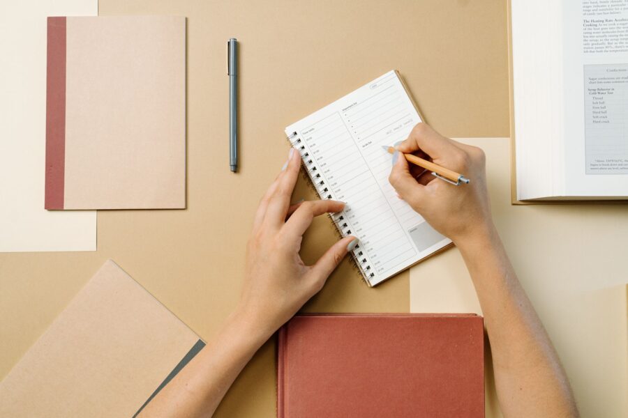 Person writing planner