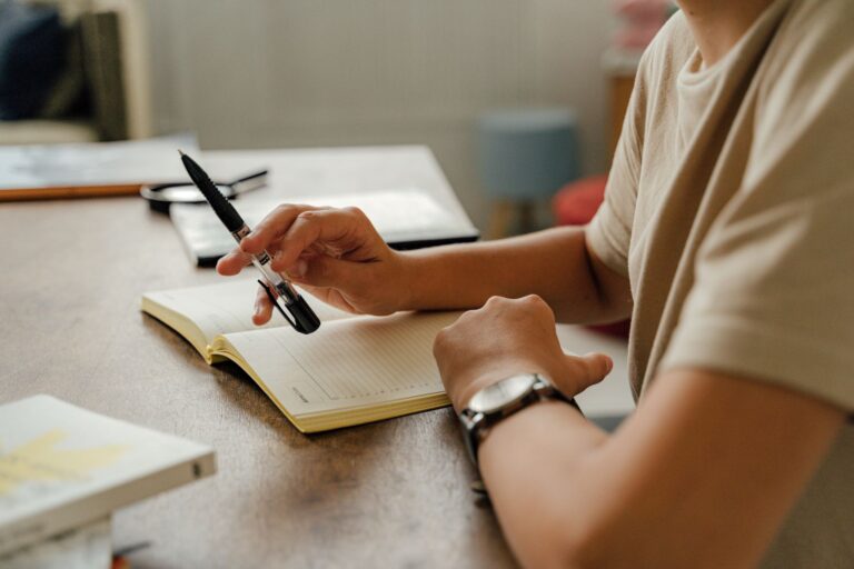 Person writing planner